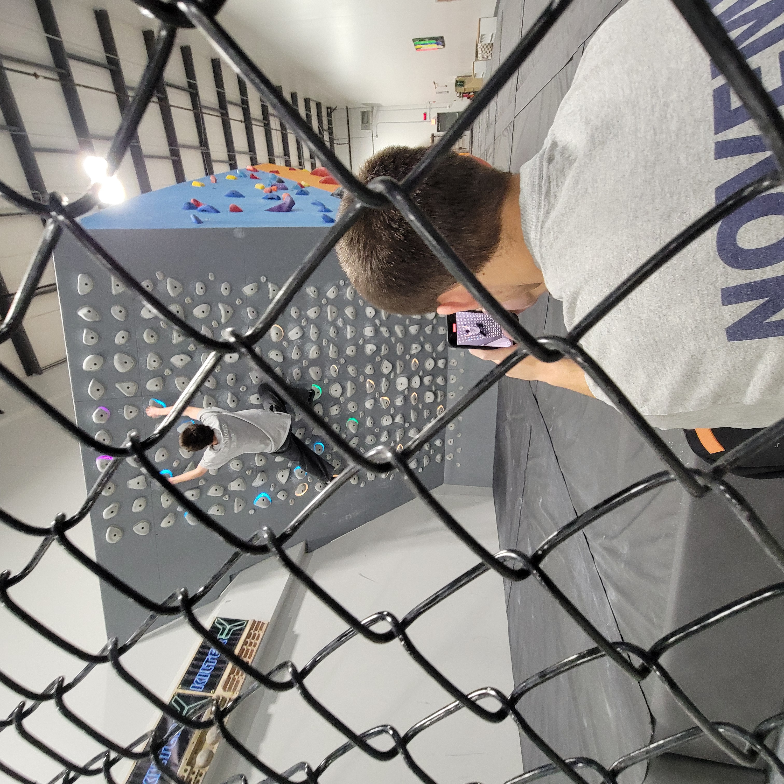 First-time climber receiving instruction at Seacoast Climb
