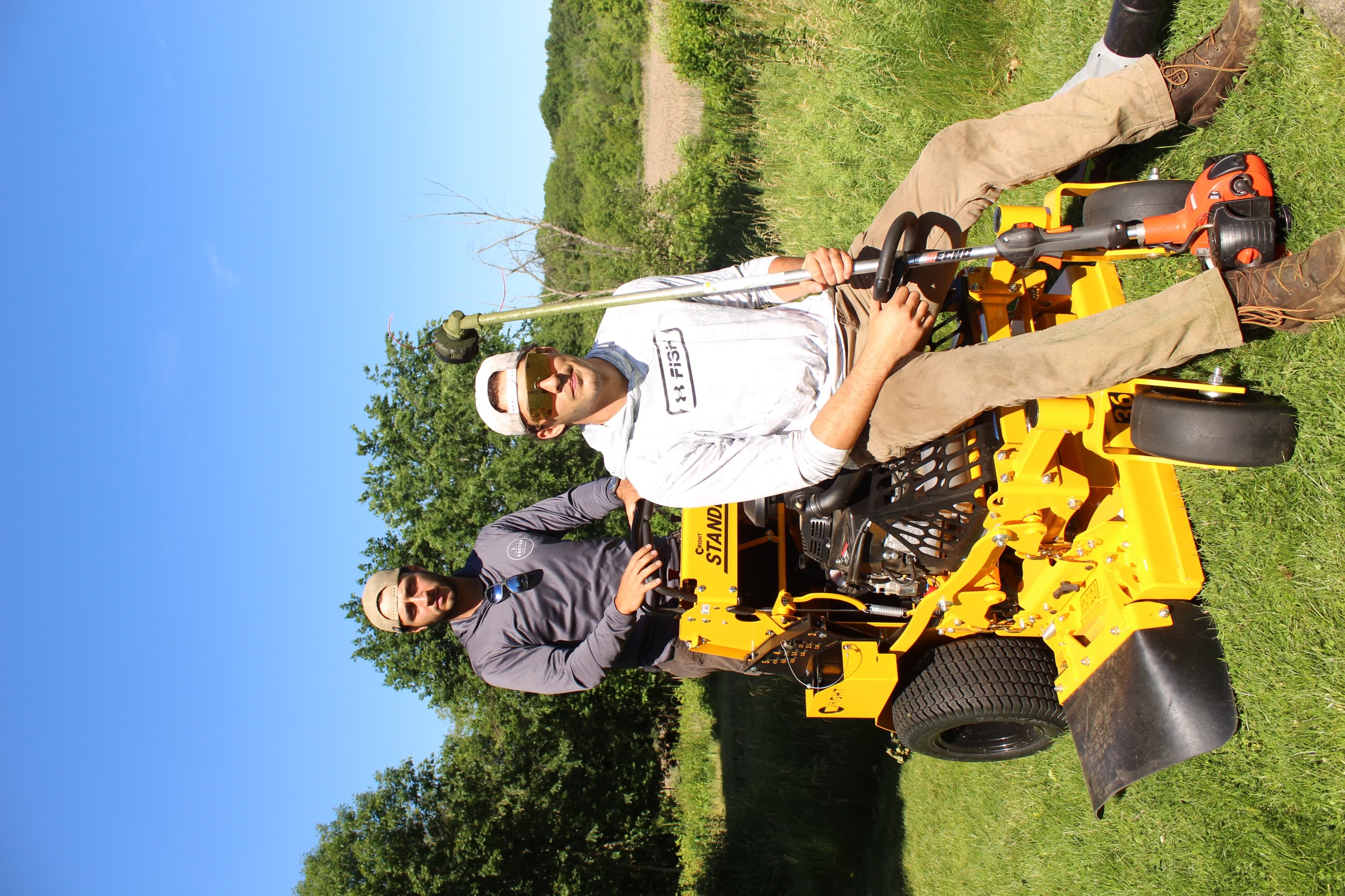 Jake's Landscaping crew mowing a residential lawn in Arlington, MA