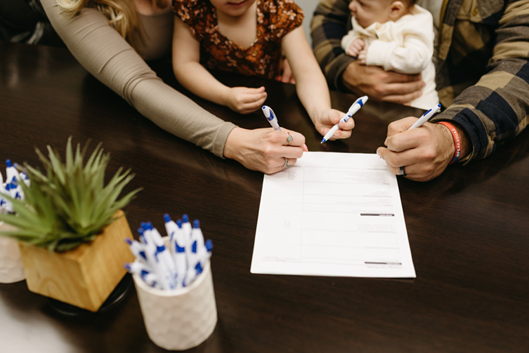 People signing documents