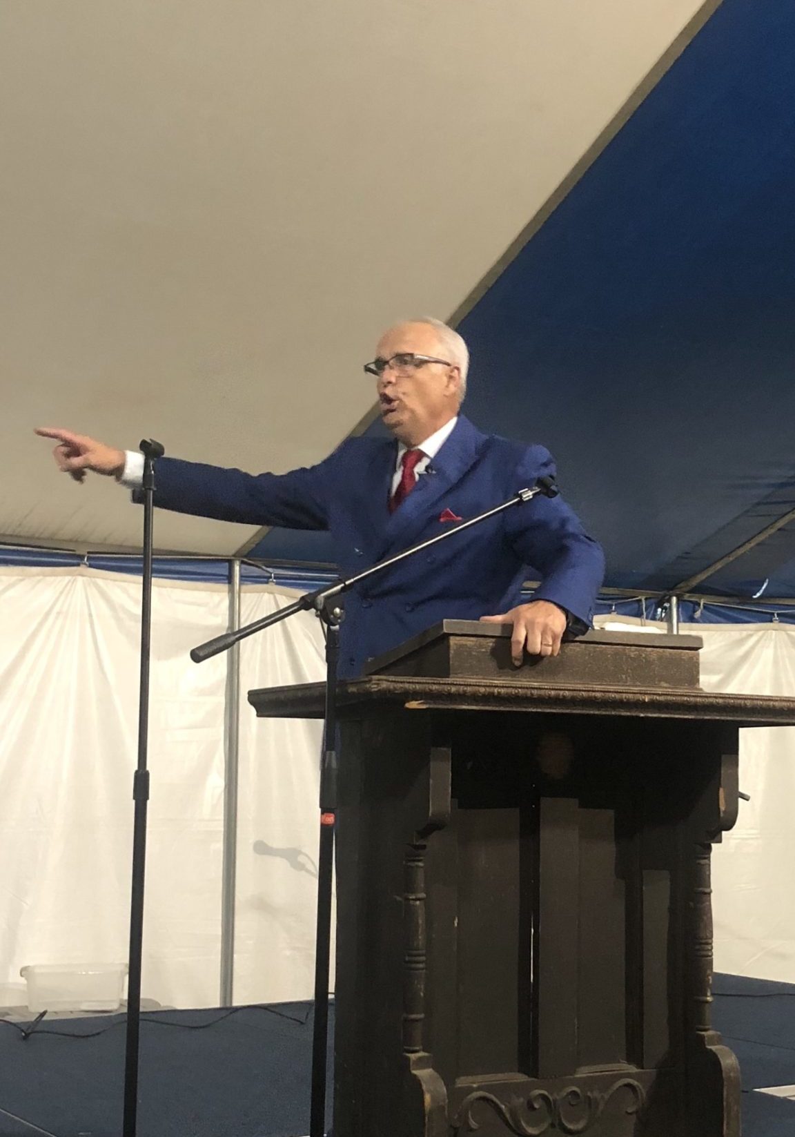 Lonnie Moore preaching at a podium