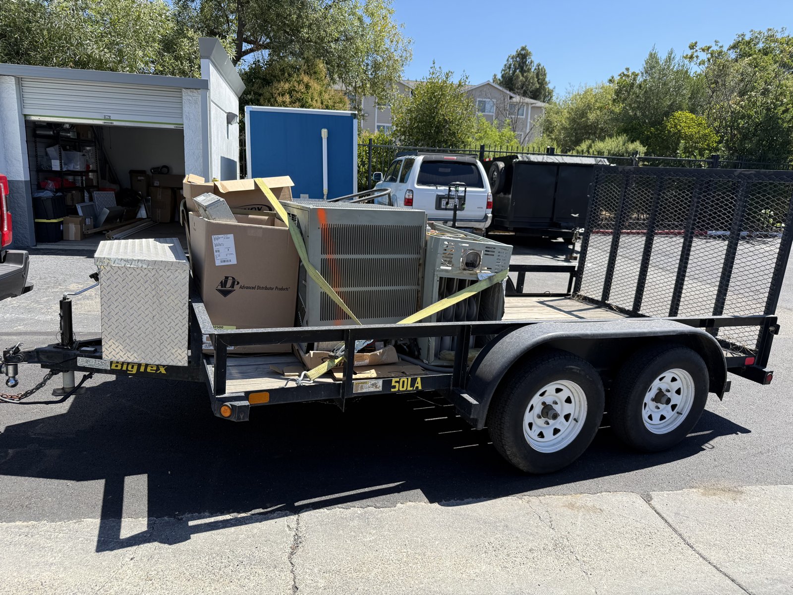 Appliances strapped onto Junk It Jim trailer for removal