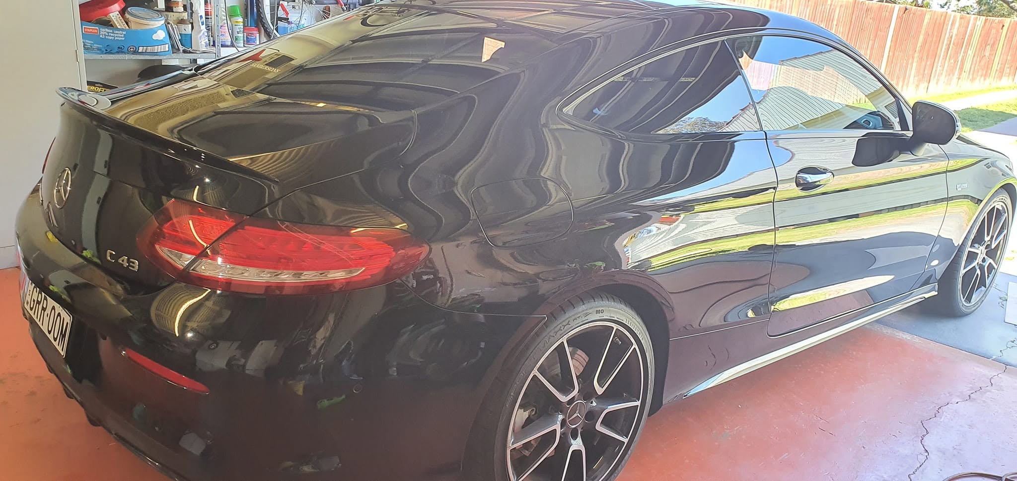Black Mercedes C43 AMG rear side view showing flawless glossy paint reflection after ceramic coating in Hills District