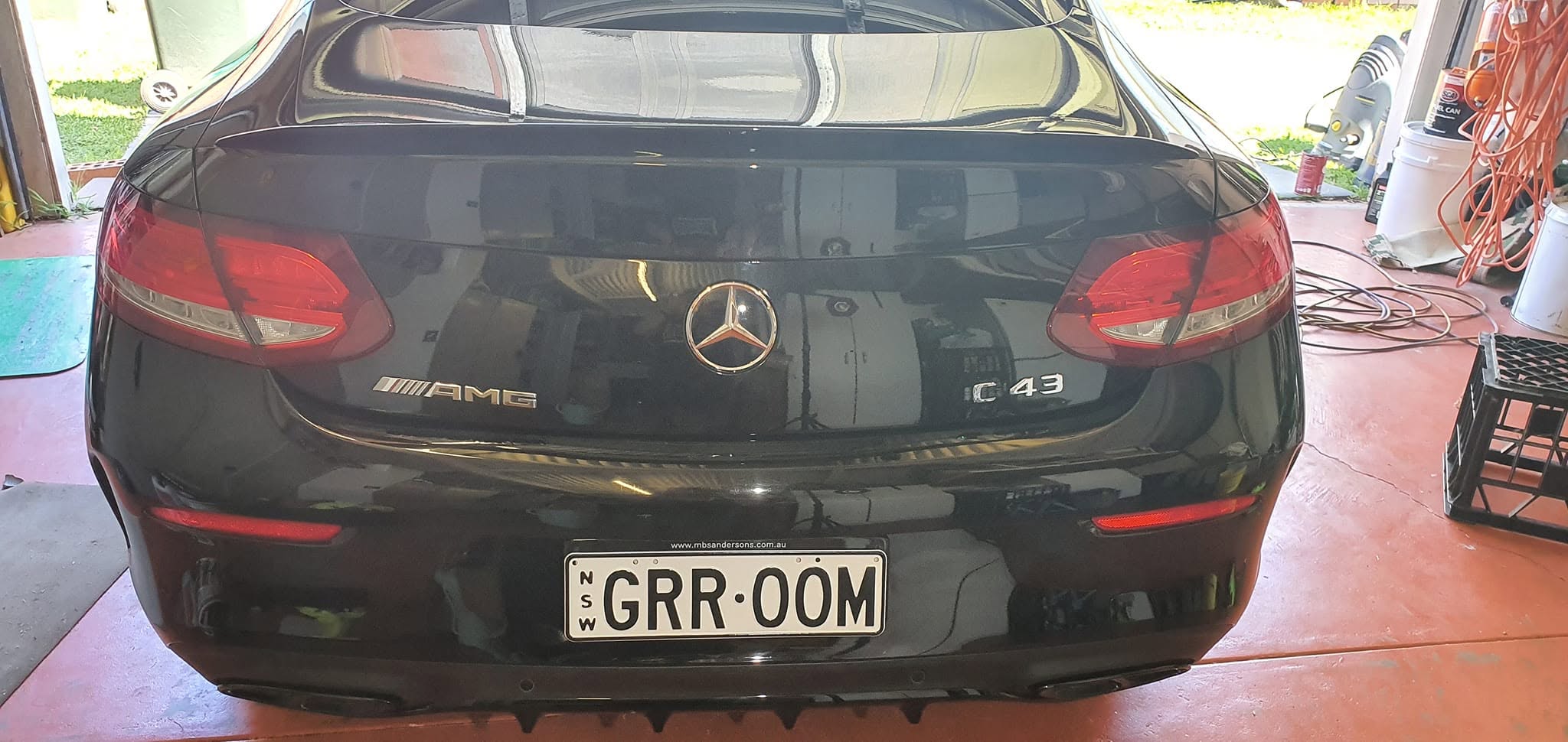 Black Mercedes C43 AMG rear view showing showroom gloss finish and GRR-OOM custom plates in Maraylya