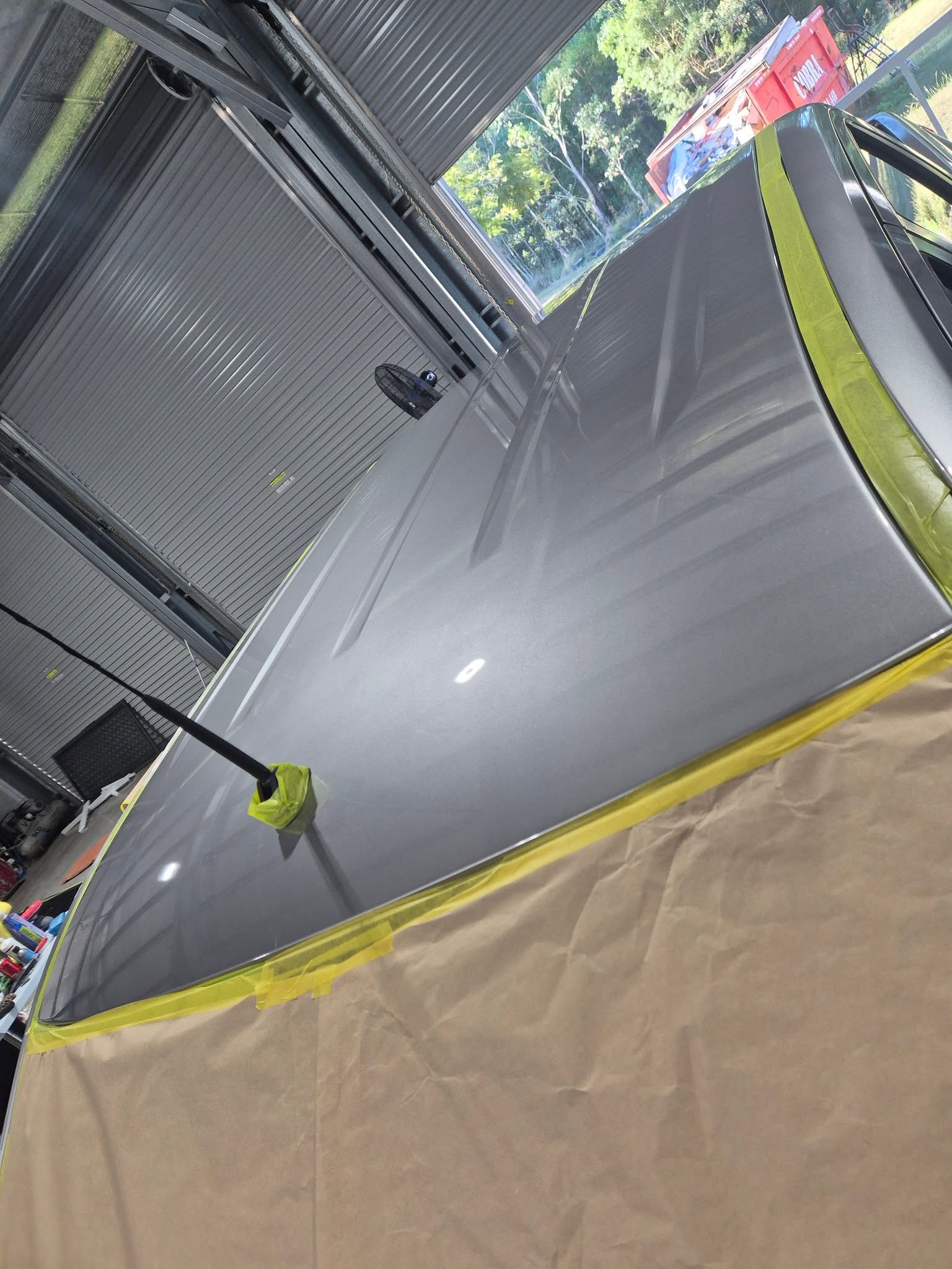 Silver car roof being prepped for paint correction and ceramic coating at Groom Garage