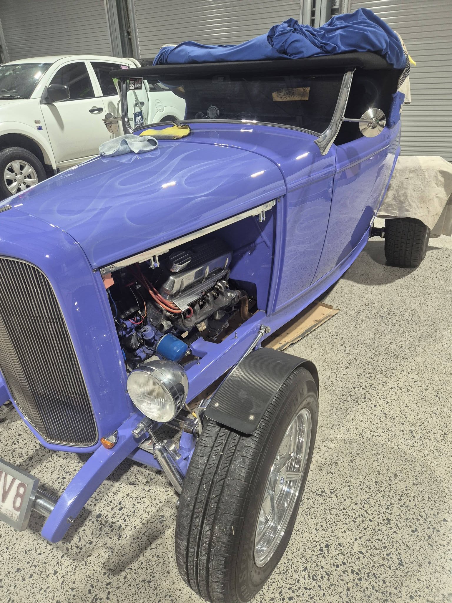 Blue hot rod front angle showing engine bay and custom paint