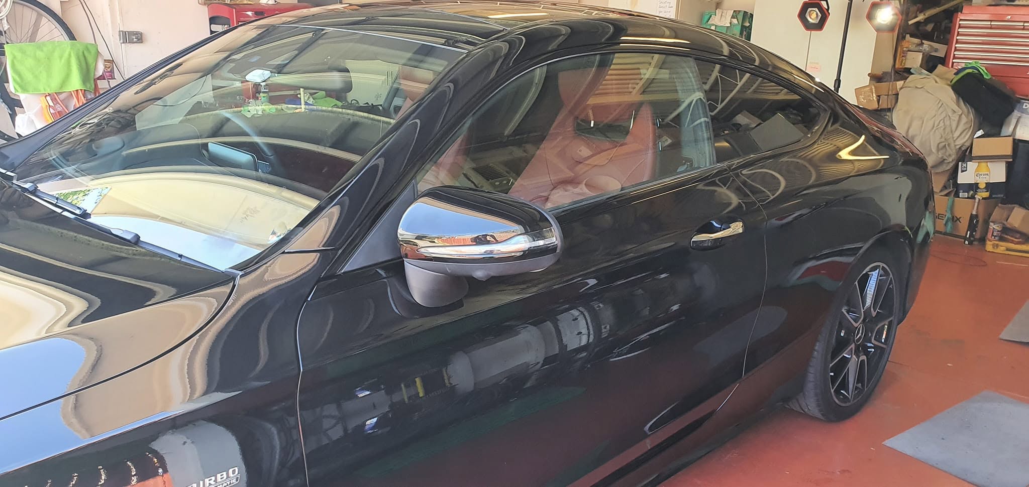 Black Mercedes side profile showing glass-like reflection after premium detailing and ceramic coating