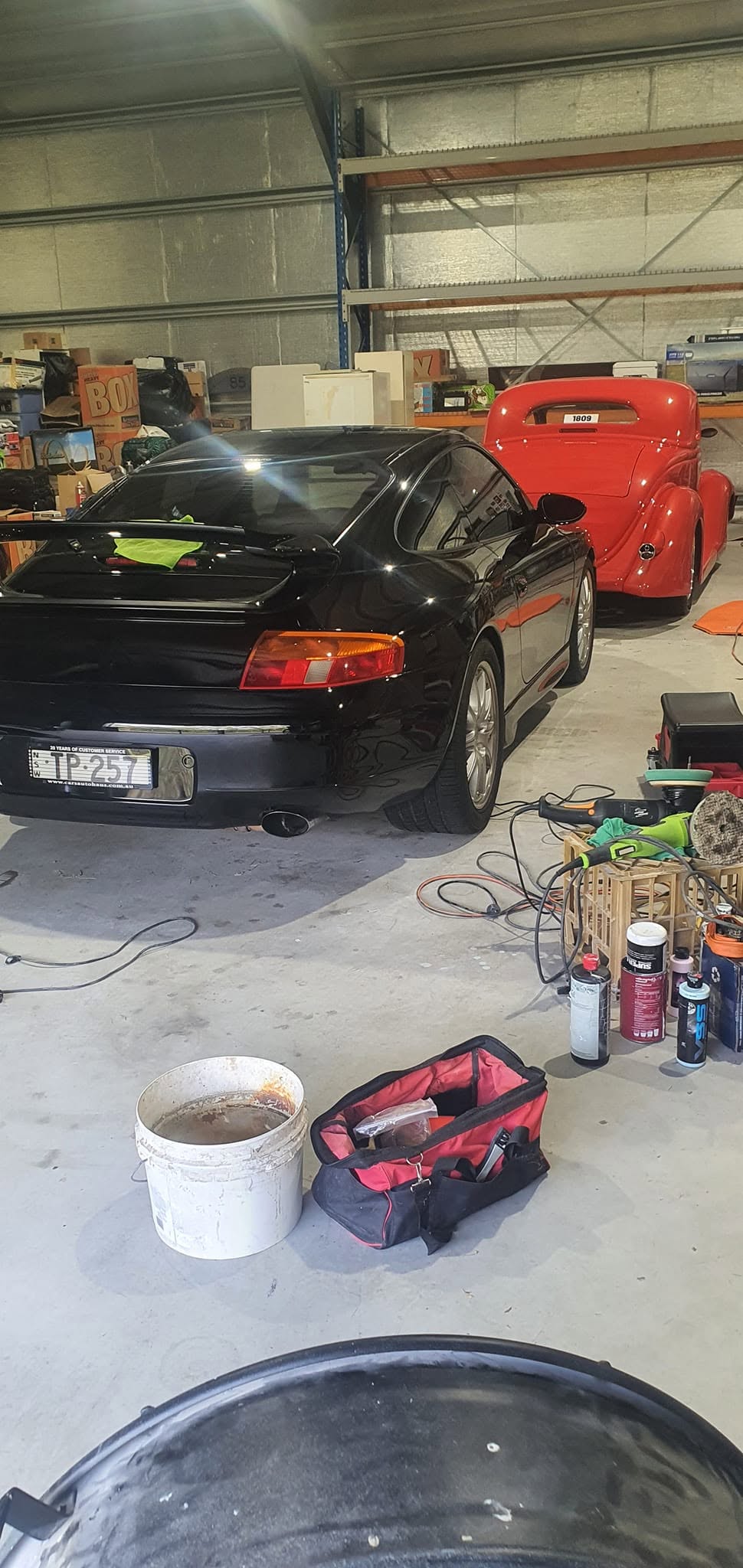 Mirror-like finish on a black car after professional polishing