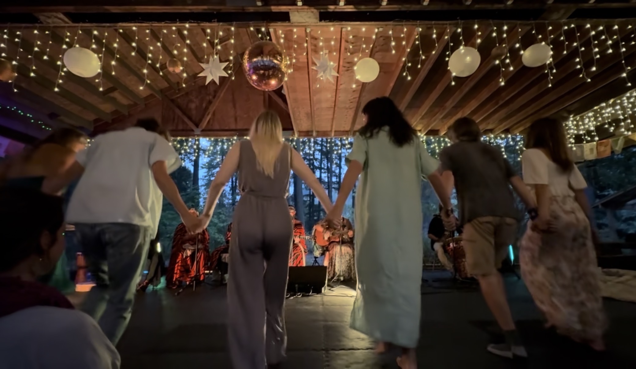 Shine Song Collective dancing in a circle