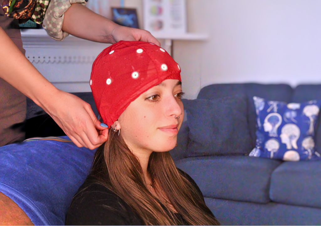 Patient wearing simple EEG cap for neurofeedback therapy