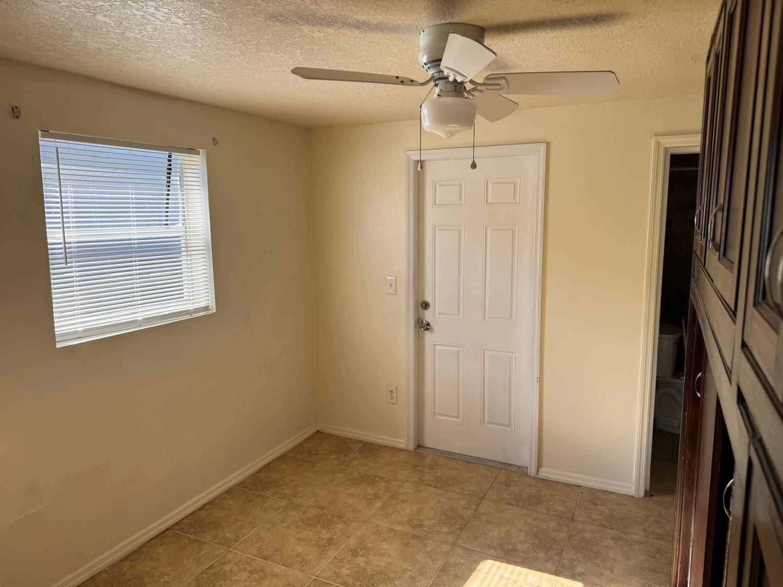 Turnkey duplex interior, move-in ready unit with tile flooring and separate utility meters in Fort