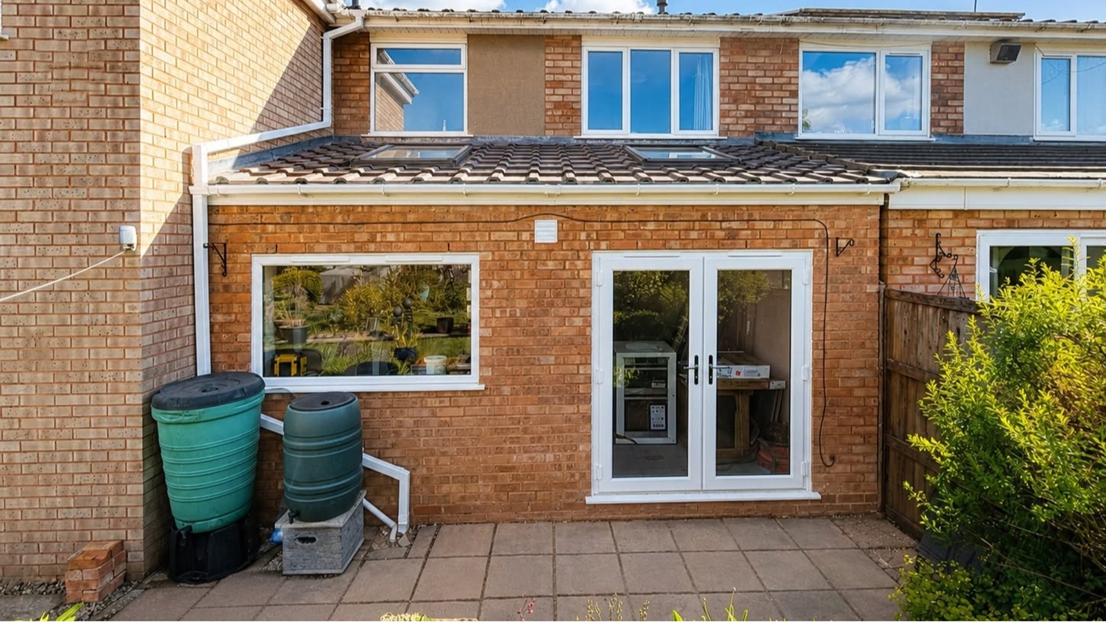 Completed rear house extension by Milano Home Improvement in Halesowen, featuring a brick-built single-storey extension with rooflights, uPVC French doors and a matching tiled roof.