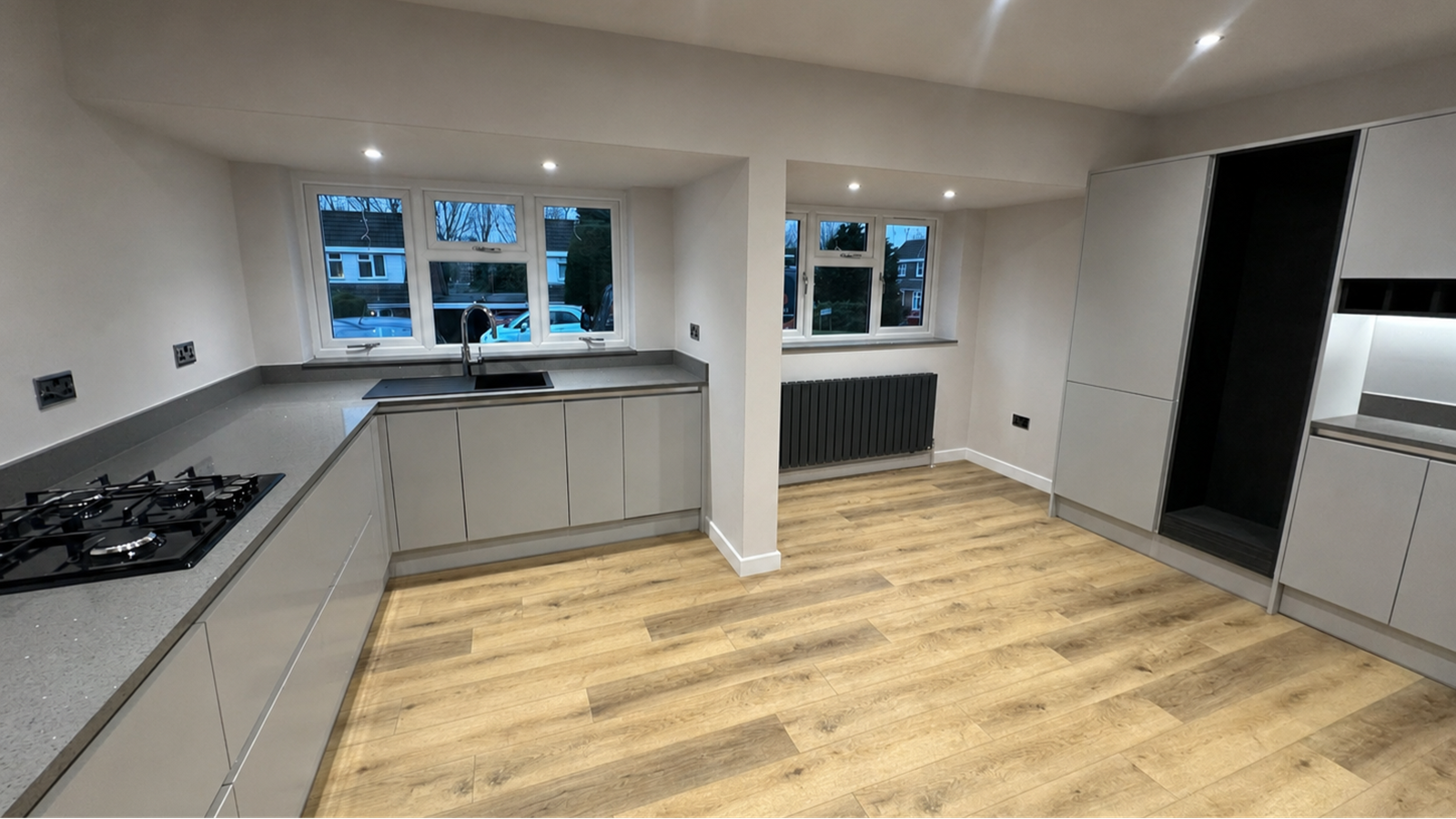Completed garage conversion into a modern kitchen and living space by Milano Home Improvement
