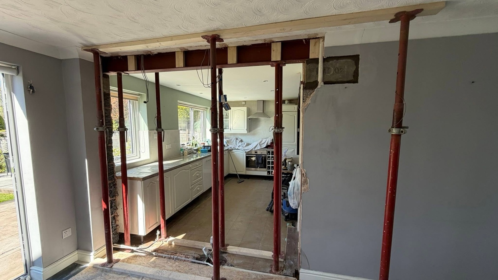Structural steel installation during a load-bearing wall alteration by Milano Home Improvement