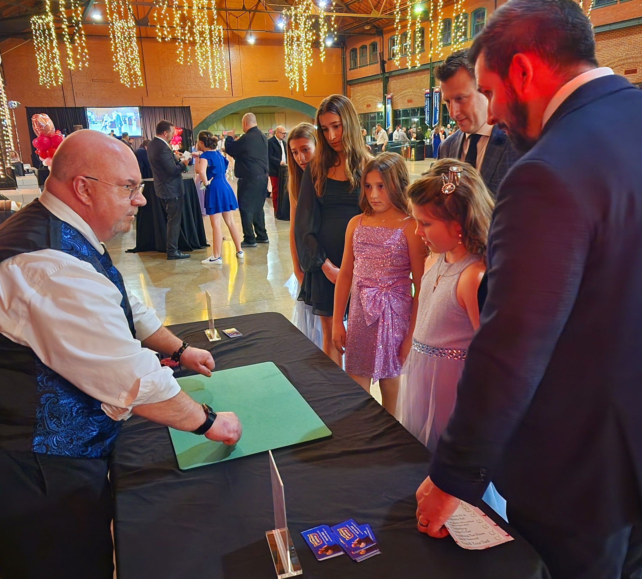 Mike Raymer performing close-up table magic at an event
