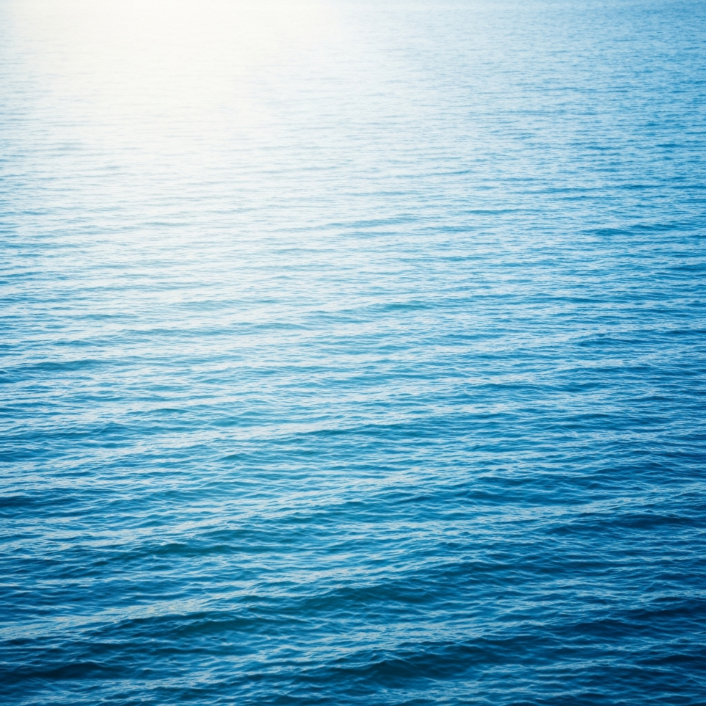 Deep blue water surface with soft light rays from above