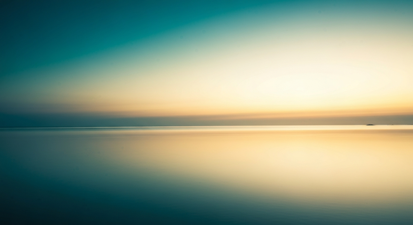 A soft golden sunrise over calm water