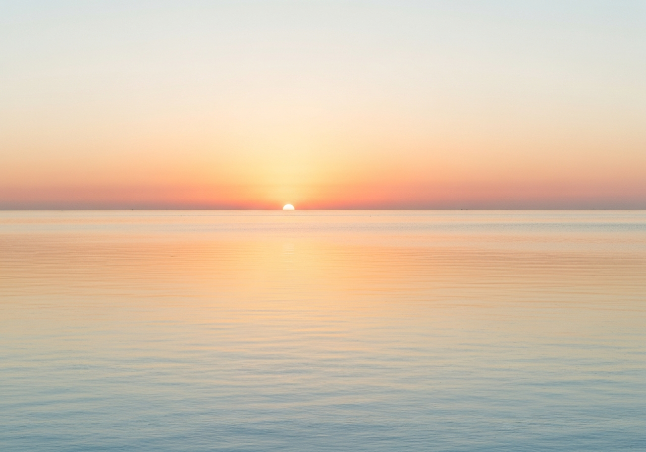 Warm coastal wellness atmosphere with sunlit water