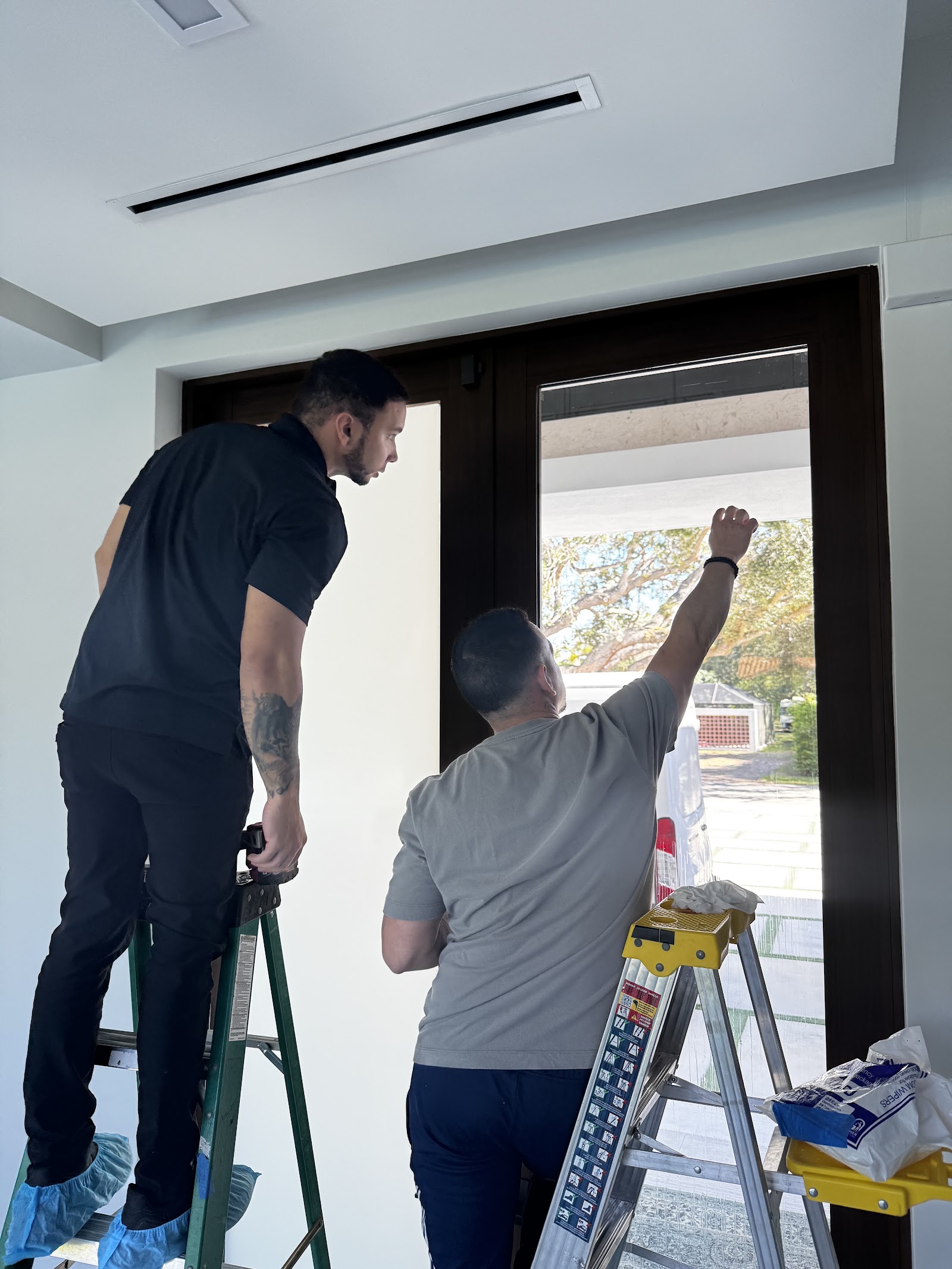 Deluxe Smart Film technician fitting switchable smart film to a glass door
