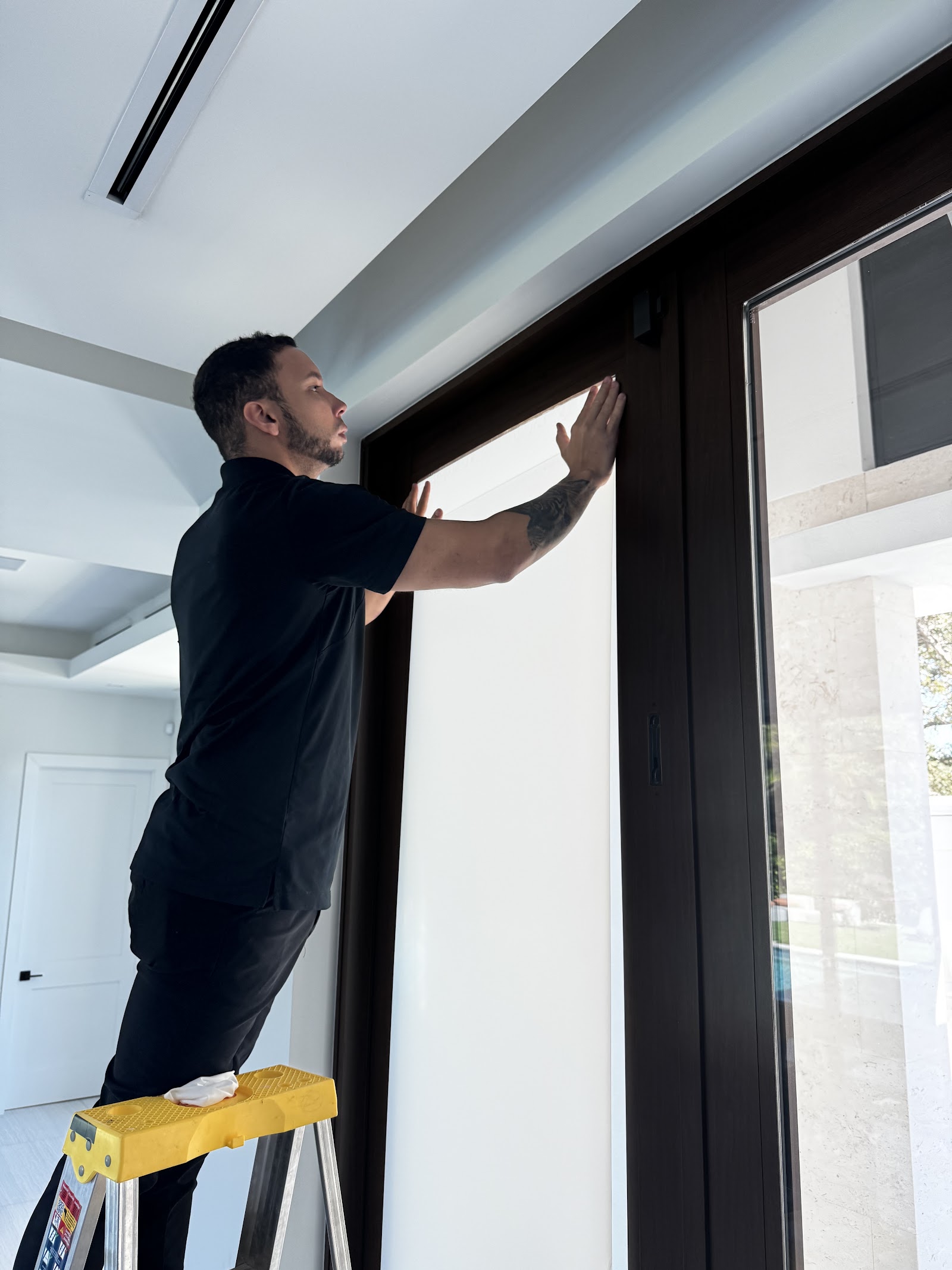 Our installer applying smart film to a glass door