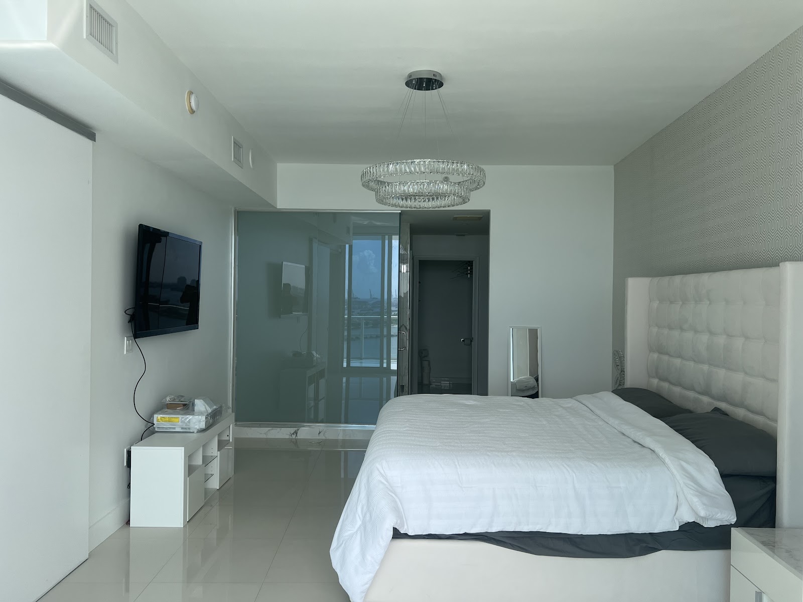 A bedroom with a smart film glass partition