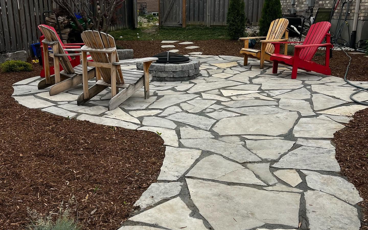 Custom stone patio and fire pit installation in London