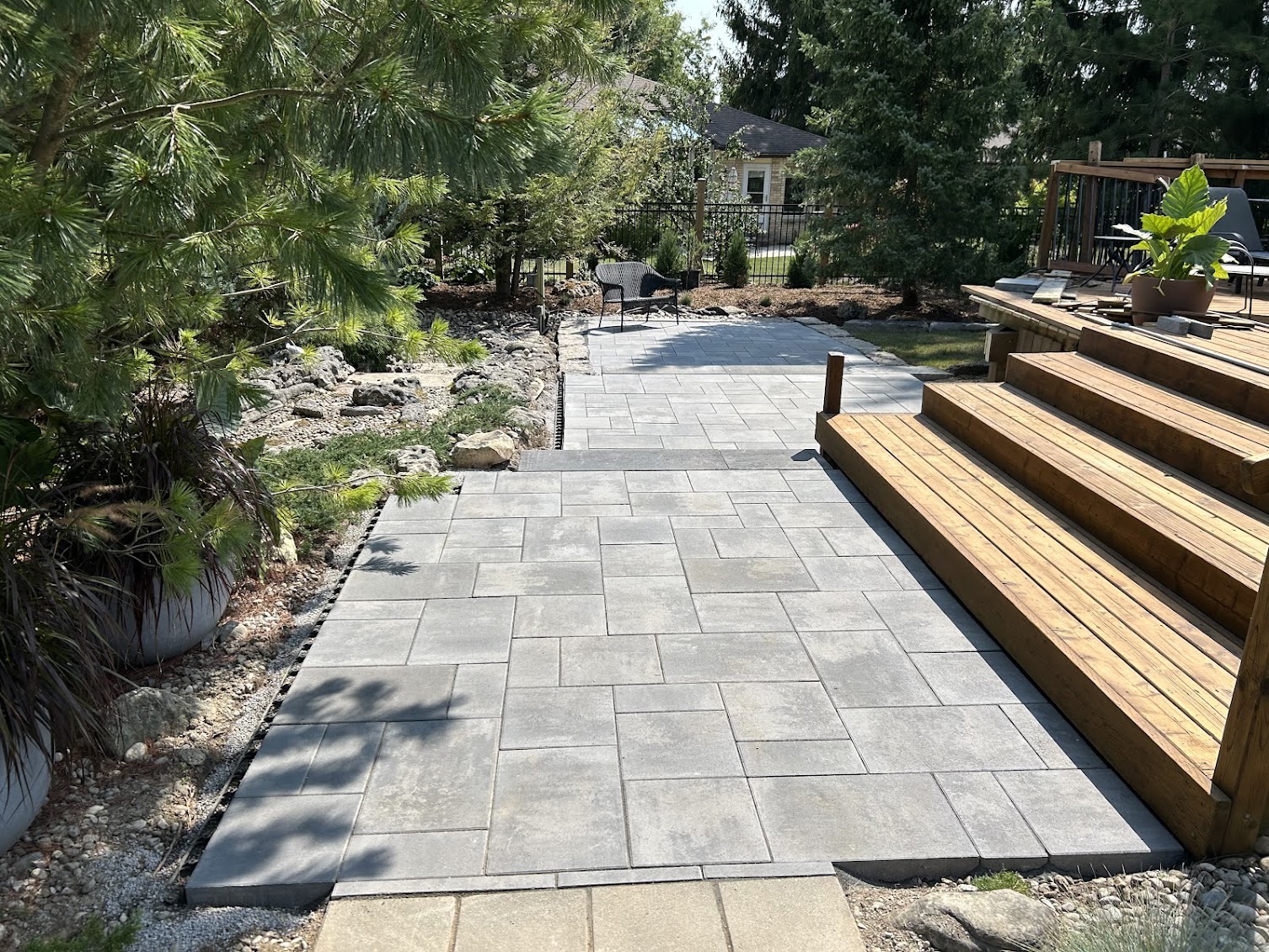 Multi-level interlocking paver patio walkway connecting garden terraces in London, Ontario