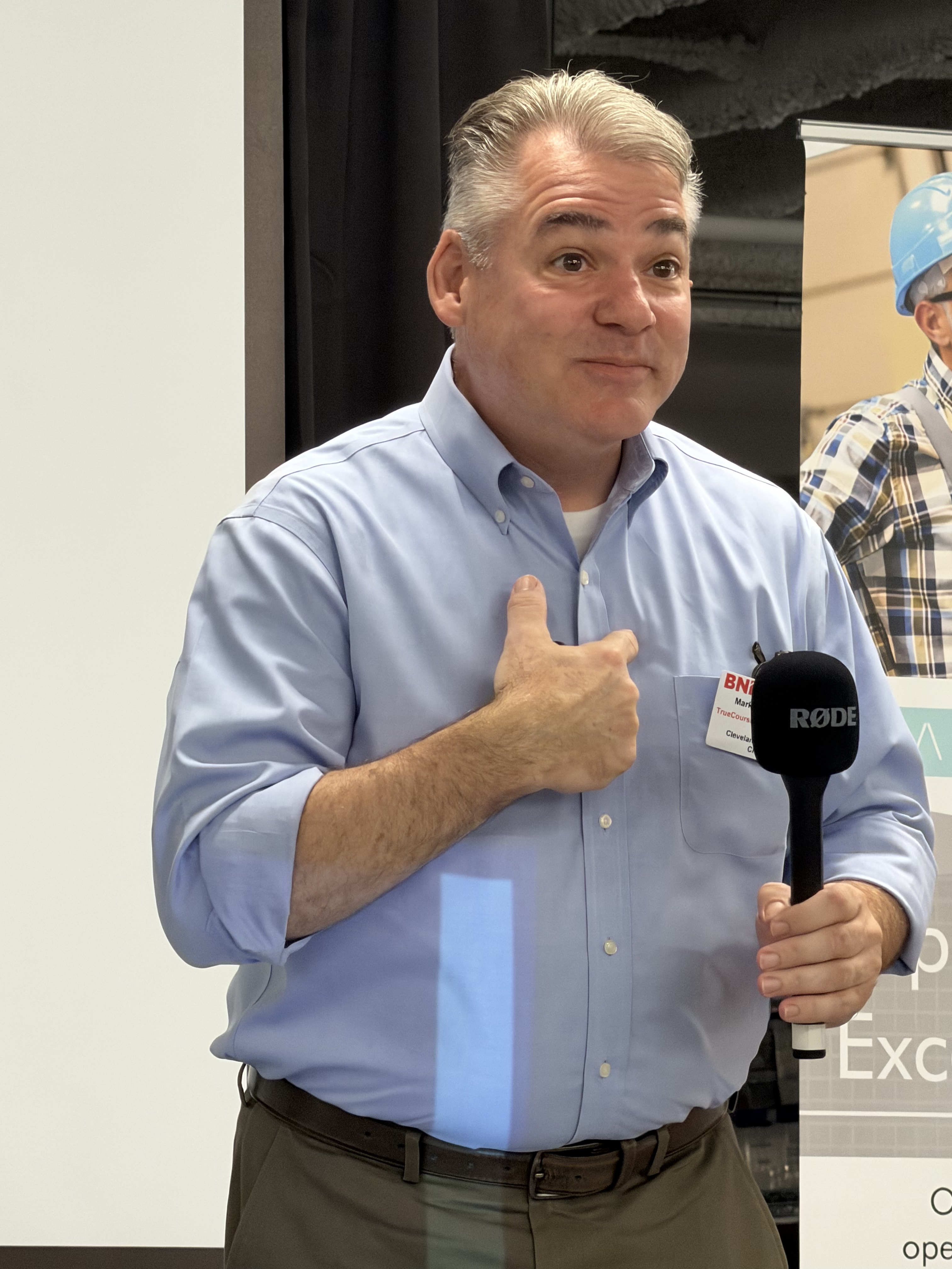 Mark speaking with microphone