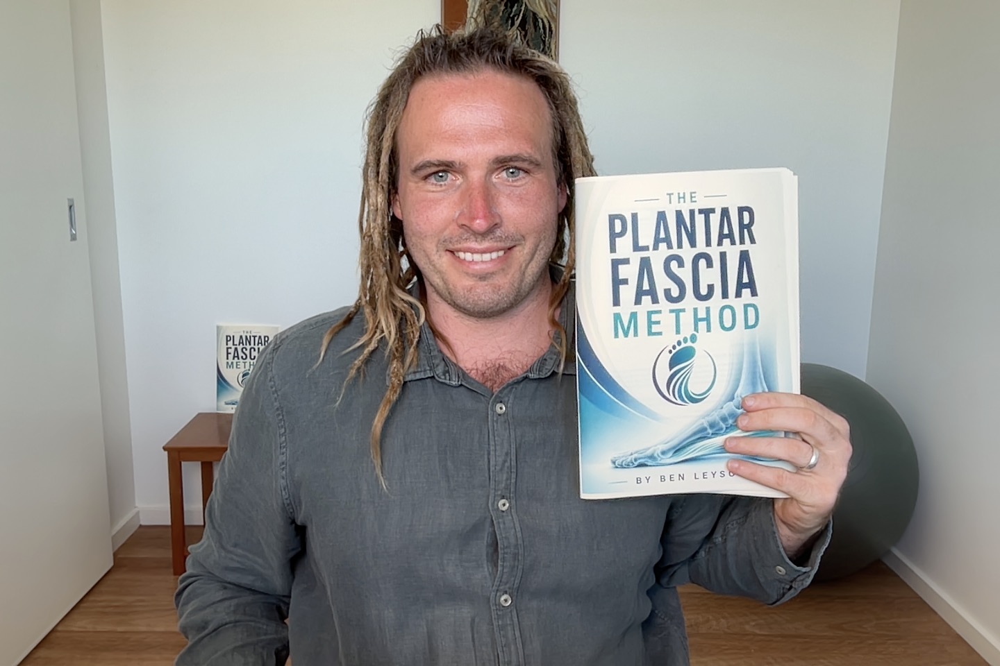 Ben Leyson holding The Plantar Fascia Method book