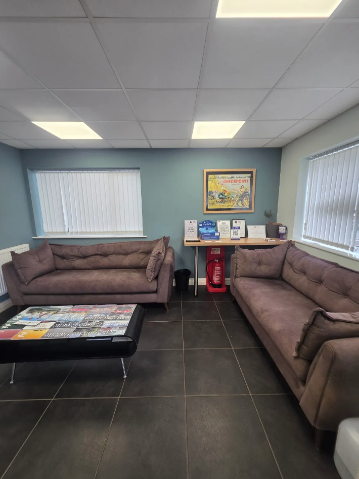 Clean modern office reception area with comfortable seating for visitors