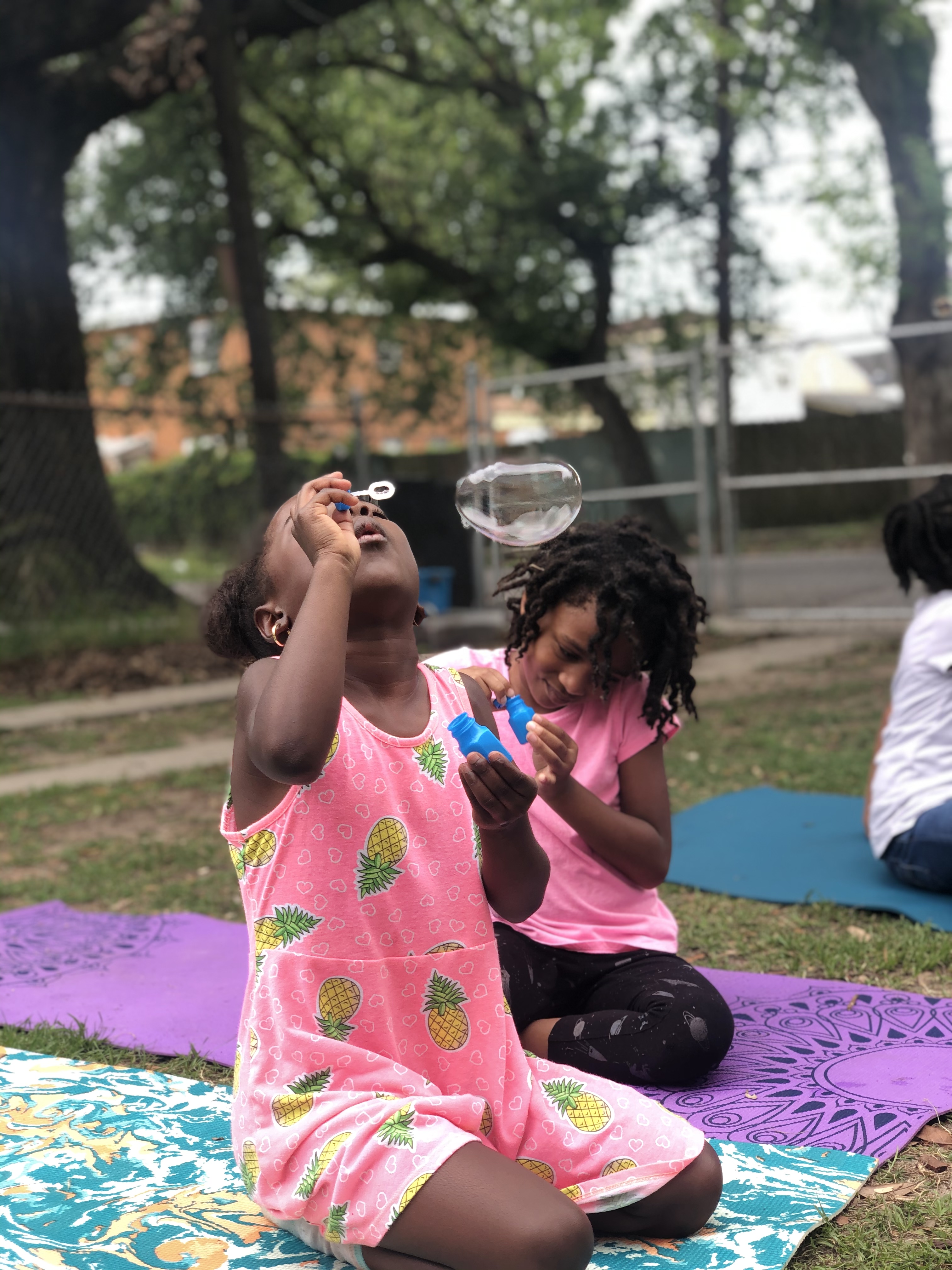 A young girl blowing bubbles practicing breath control