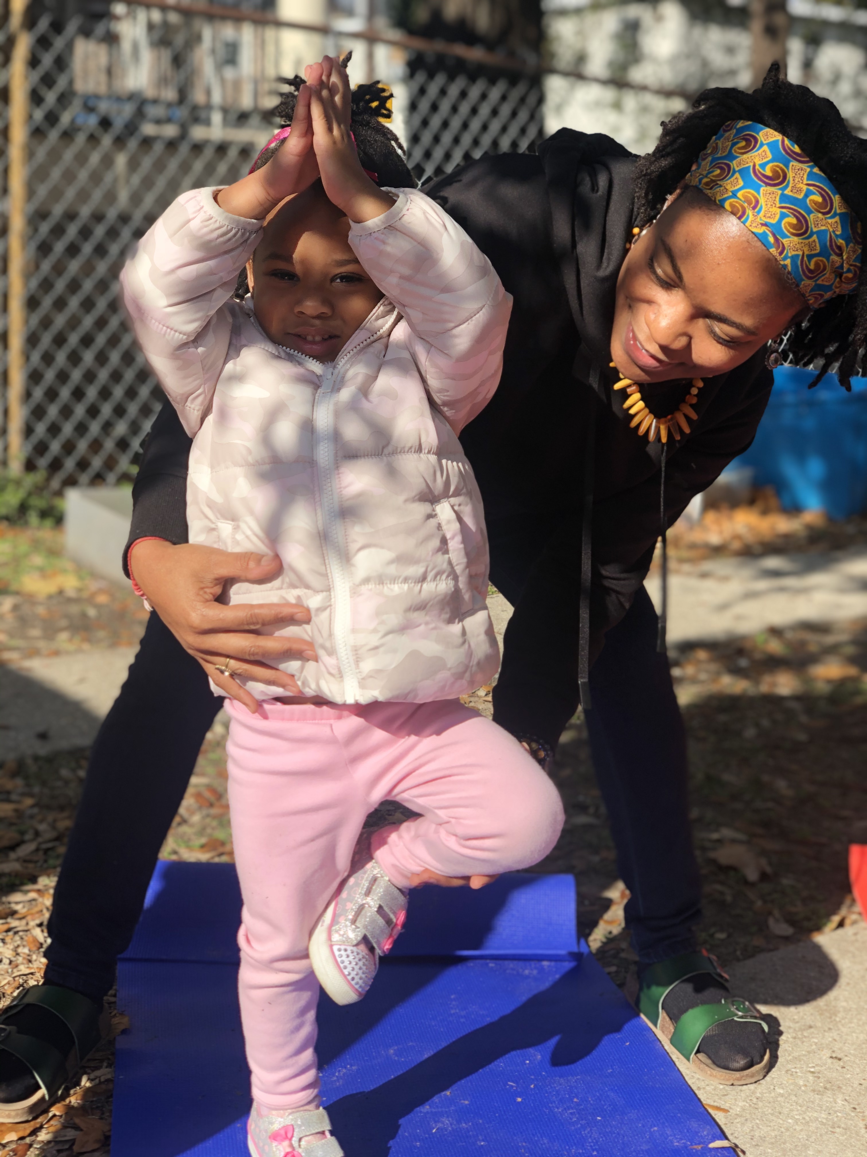 Nicole from Amaru Homeschool in New Orleans helping her student with yoga