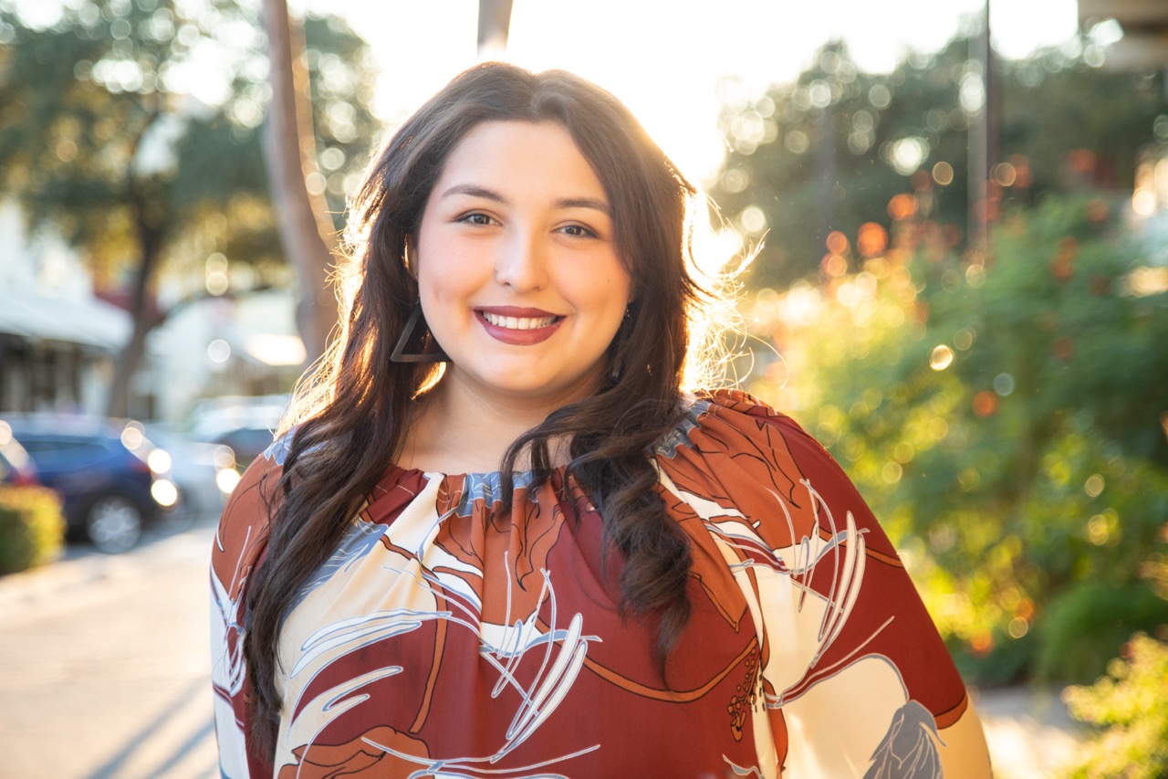 On-location professional headshot — woman in floral top downtown