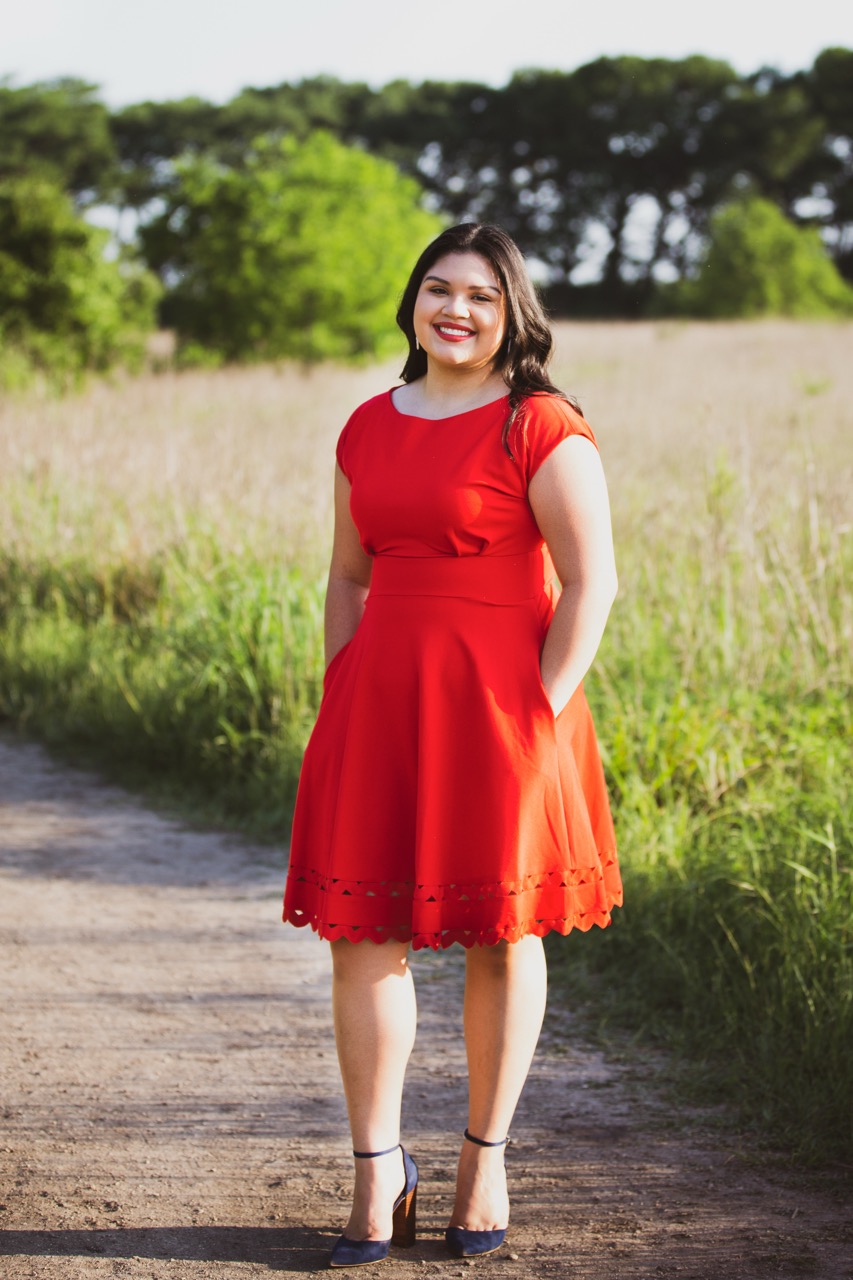 On-location professional headshot — woman in red dress on country road