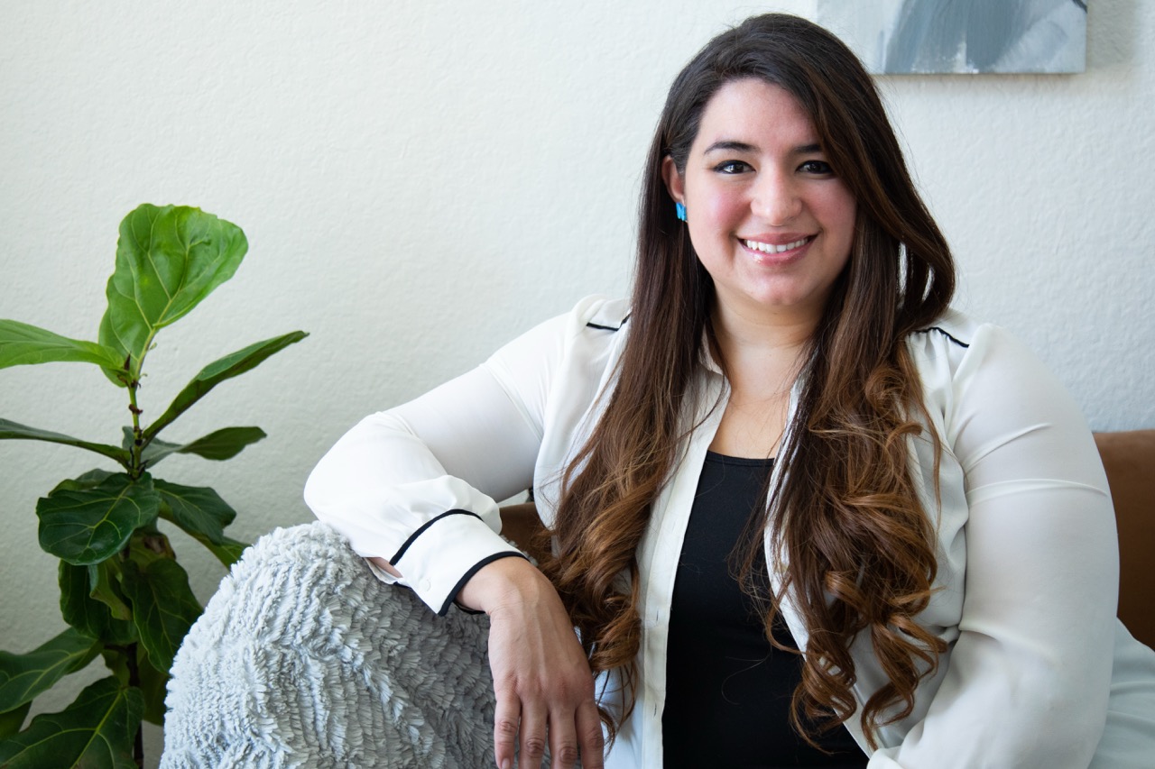 On-location professional headshot — woman with long hair smiling