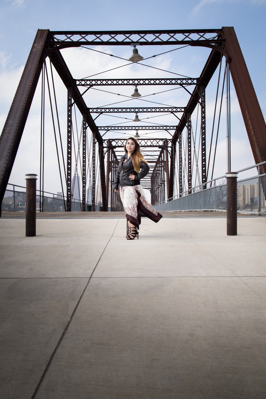 On-location professional headshot — woman in leather jacket on bridge
