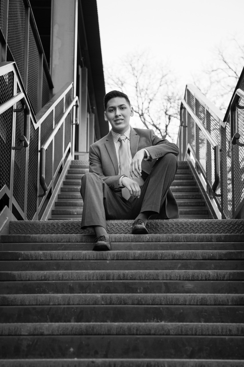 On-location professional headshot — man in suit sitting on stairs (B&W)