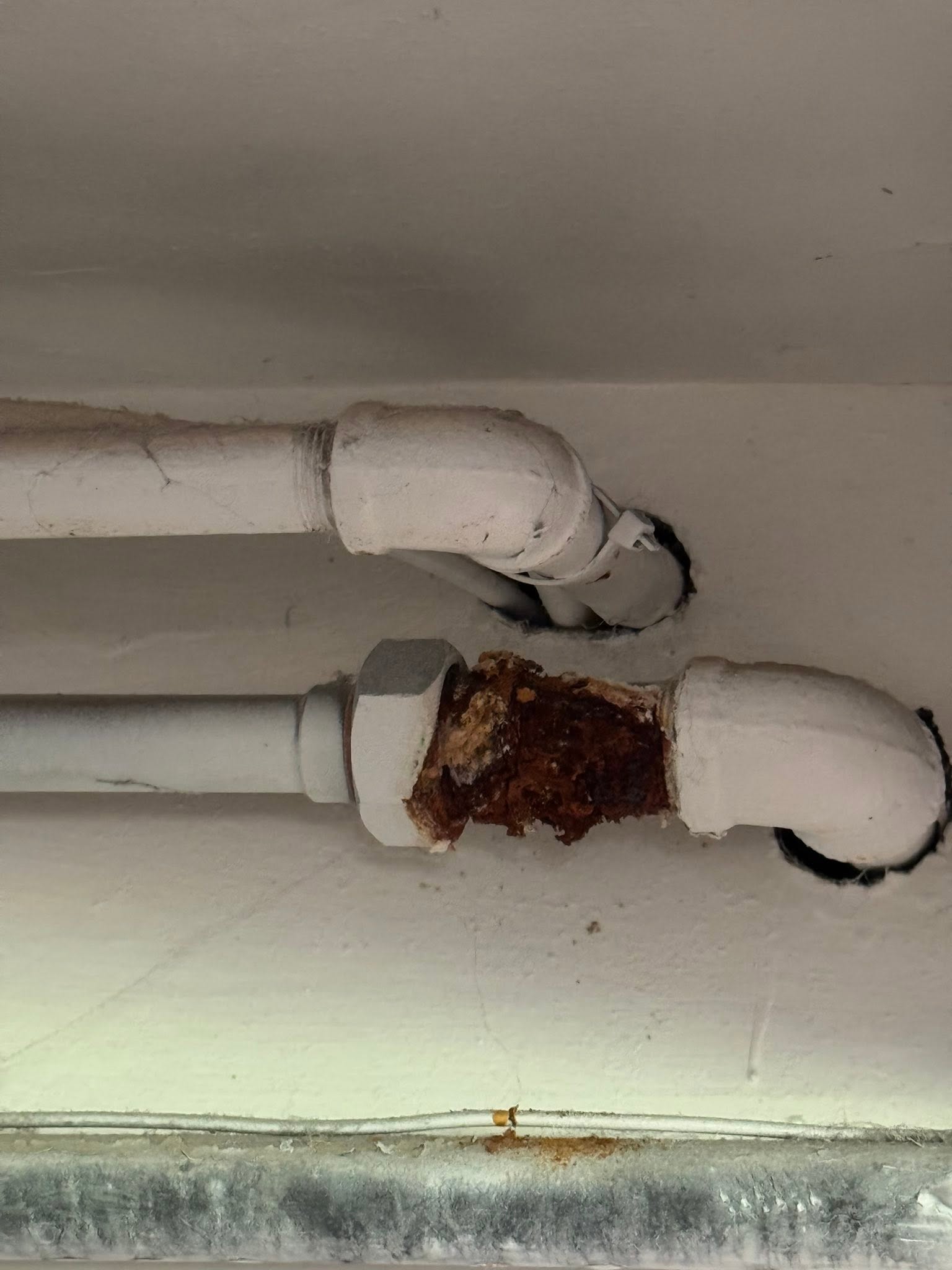 Before repiping - old corroded galvanized pipe with rust and leaks