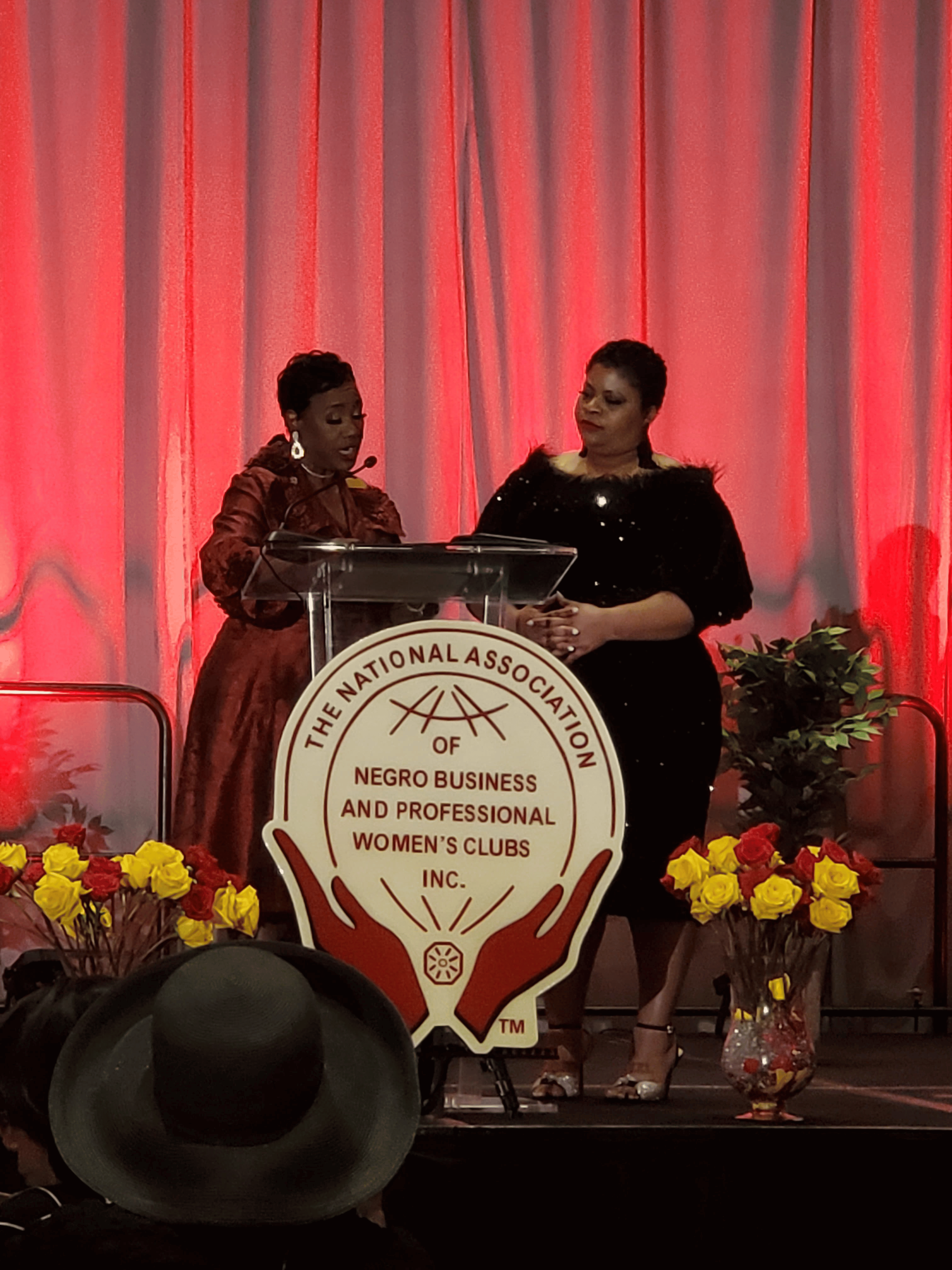 Two speakers at the podium at the NANBPWC event
