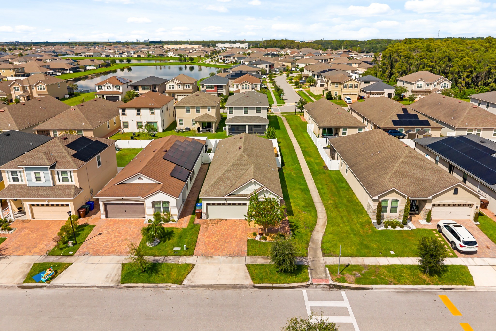 2401 Avian Loop Kissimmee FL - Aerial view showing the home and streetscape setting within the surrounding Tapestry community