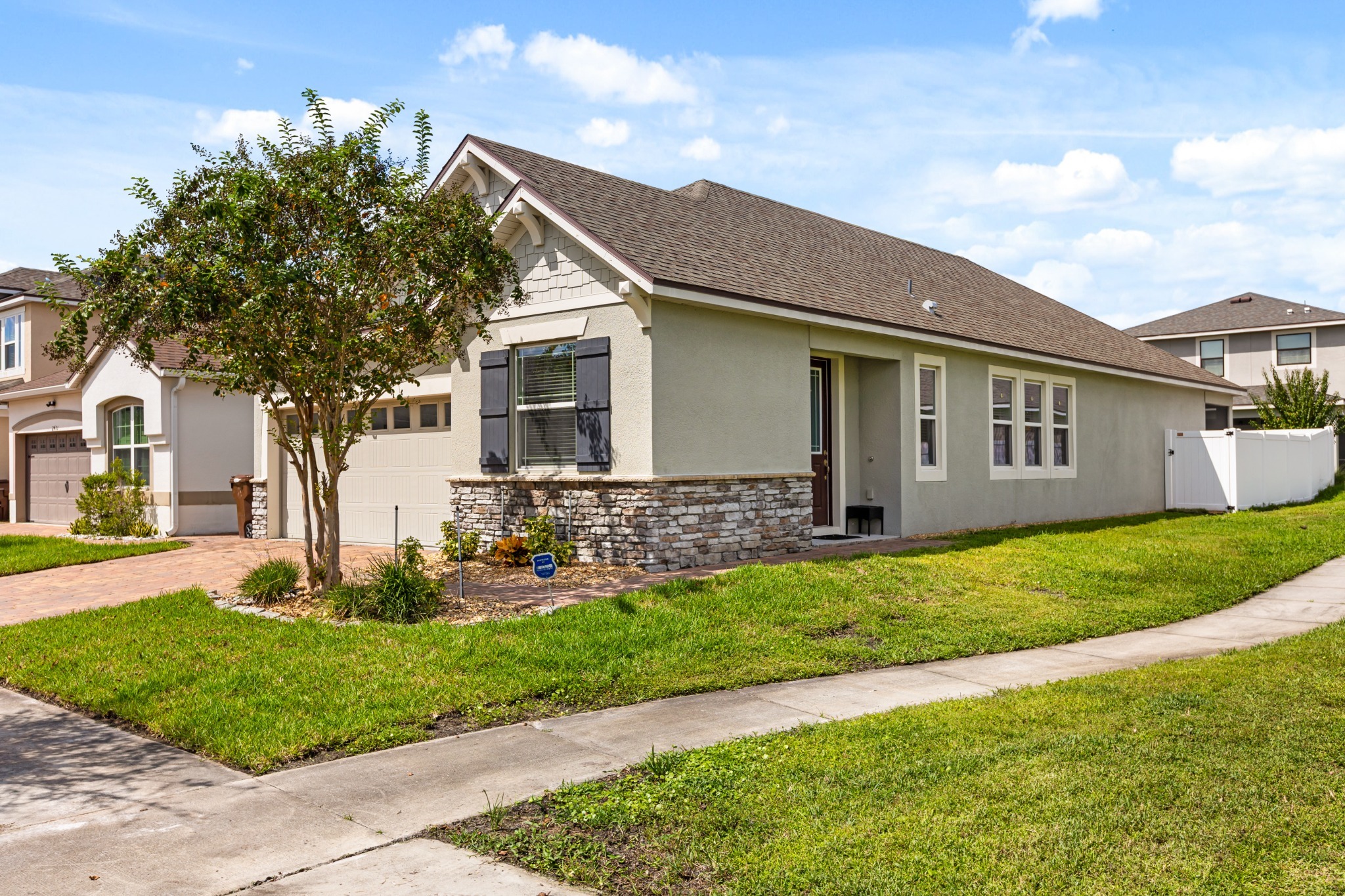 2401 Avian Loop Kissimmee FL - Wider angled front exterior elevation showing architectural facade and landscaped setting in Tapestry