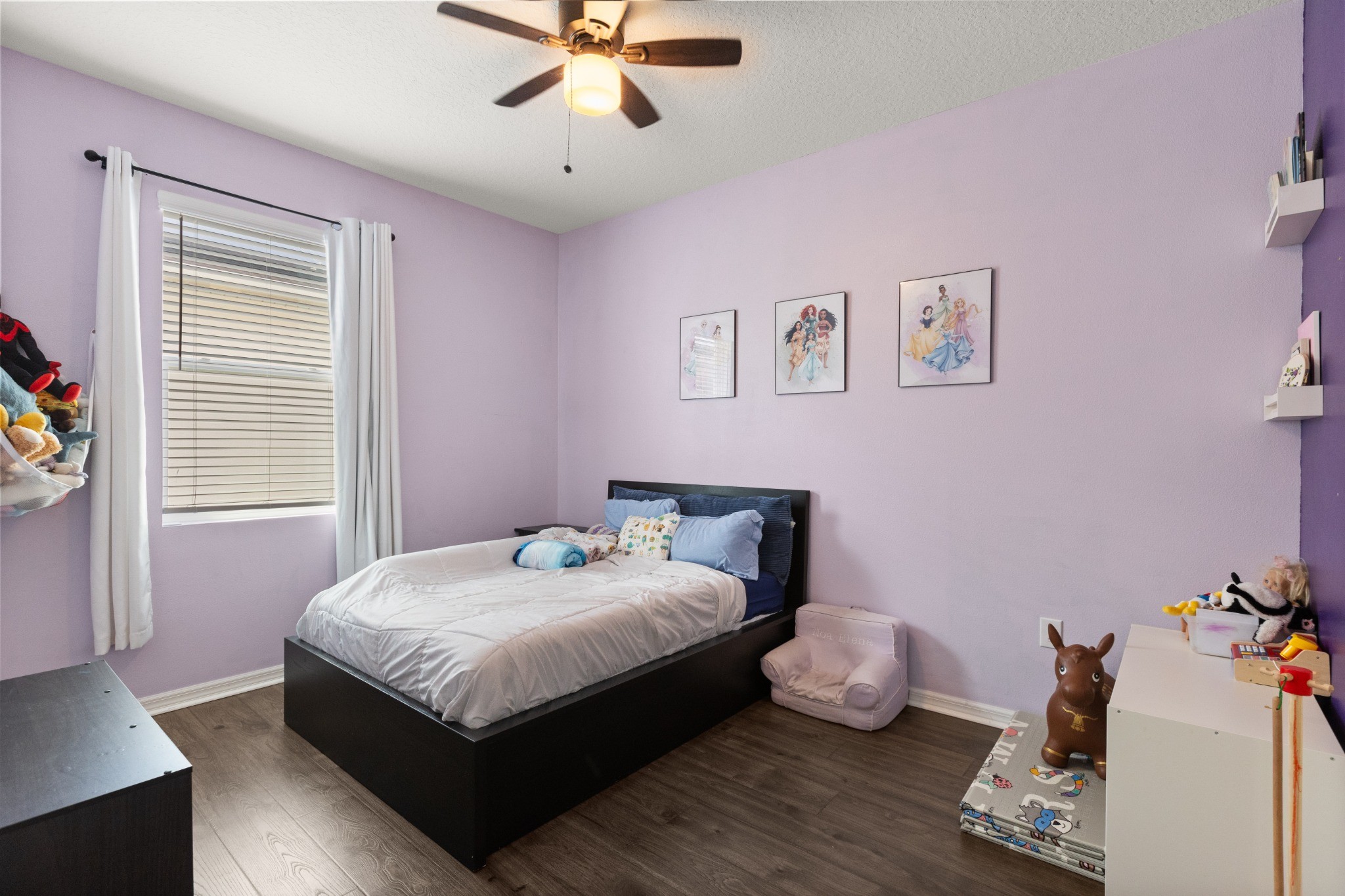 2401 Avian Loop Kissimmee FL - Secondary bedroom with natural light, wood-look flooring, ceiling fan, and closet