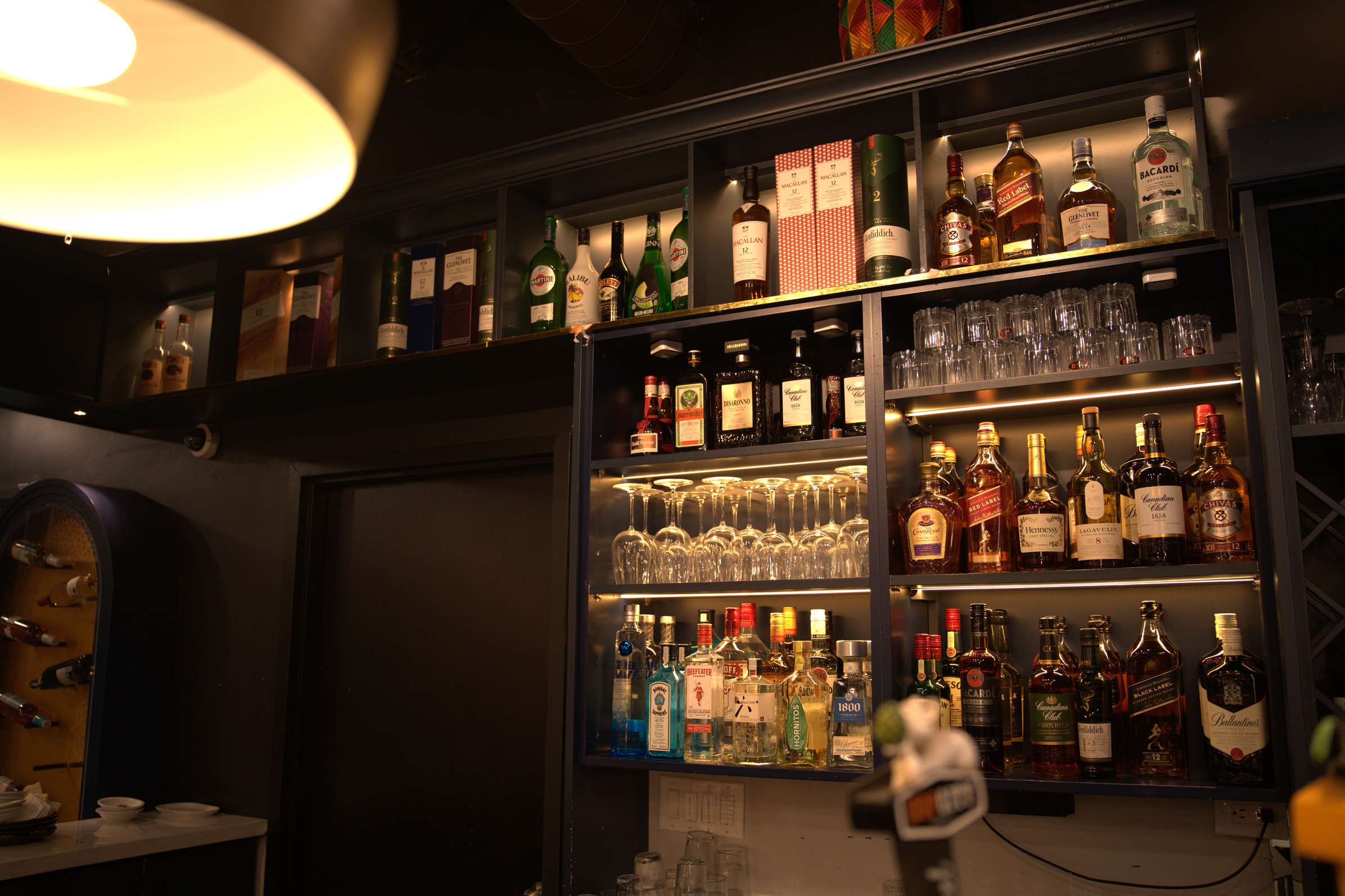 Premium liquor collection with backlit shelves at Khatirdari bar in Brampton Ontario