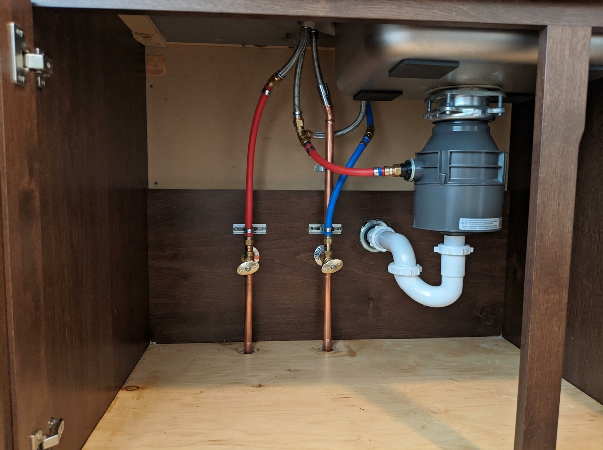 Clean copper PEX repiping under sink after installation in Goodyear, AZ