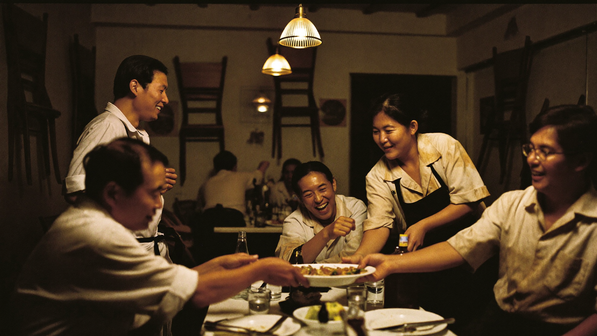 Restaurant team sharing a meal together after service