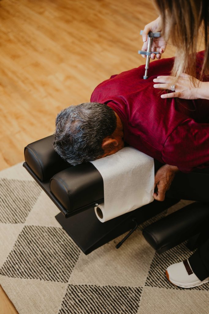 Chiropractor adjusting patient's mid-back