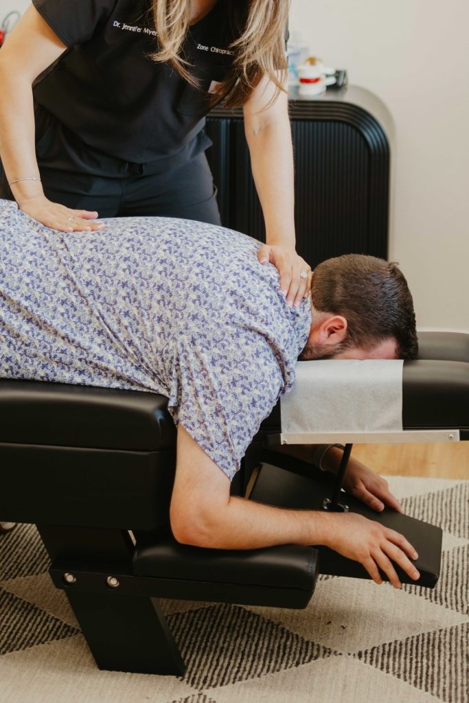 Chiropractor adjusting a patient's back