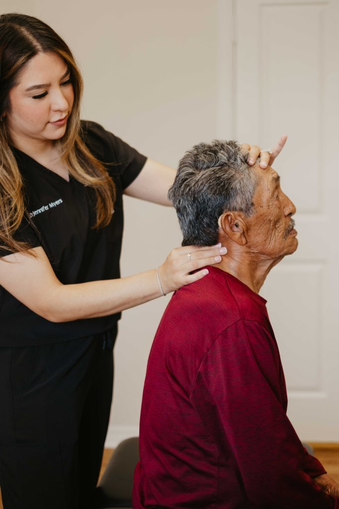 Chiropractor examining patient's neck