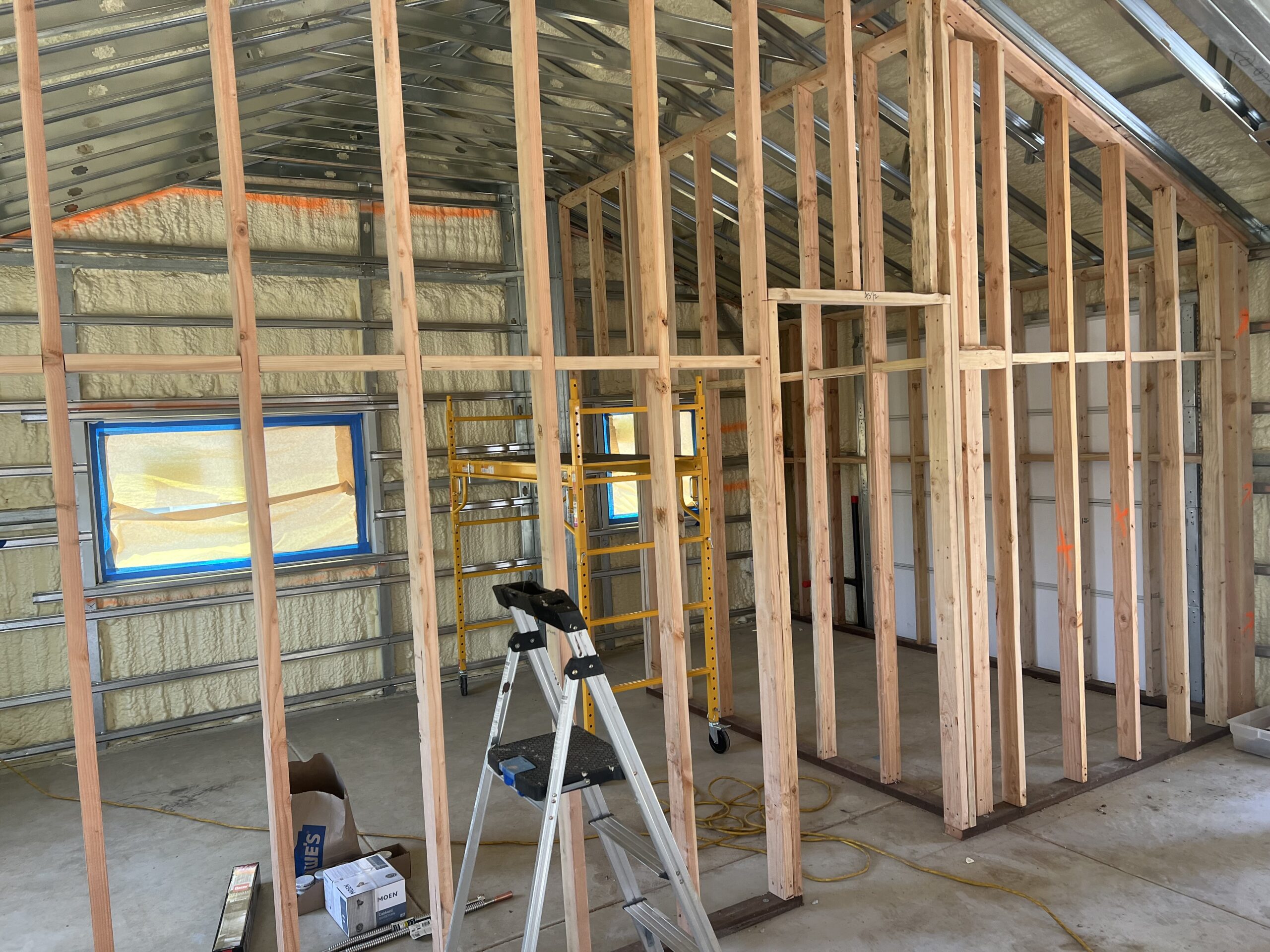 Wood partition walls being framed inside an insulated steel building.