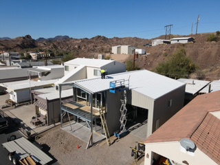 Aerial view of a steel-framed building addition in a Southern California neighborhood.