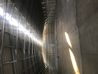Completed warehouse interior with daylight entering through translucent roof panels.